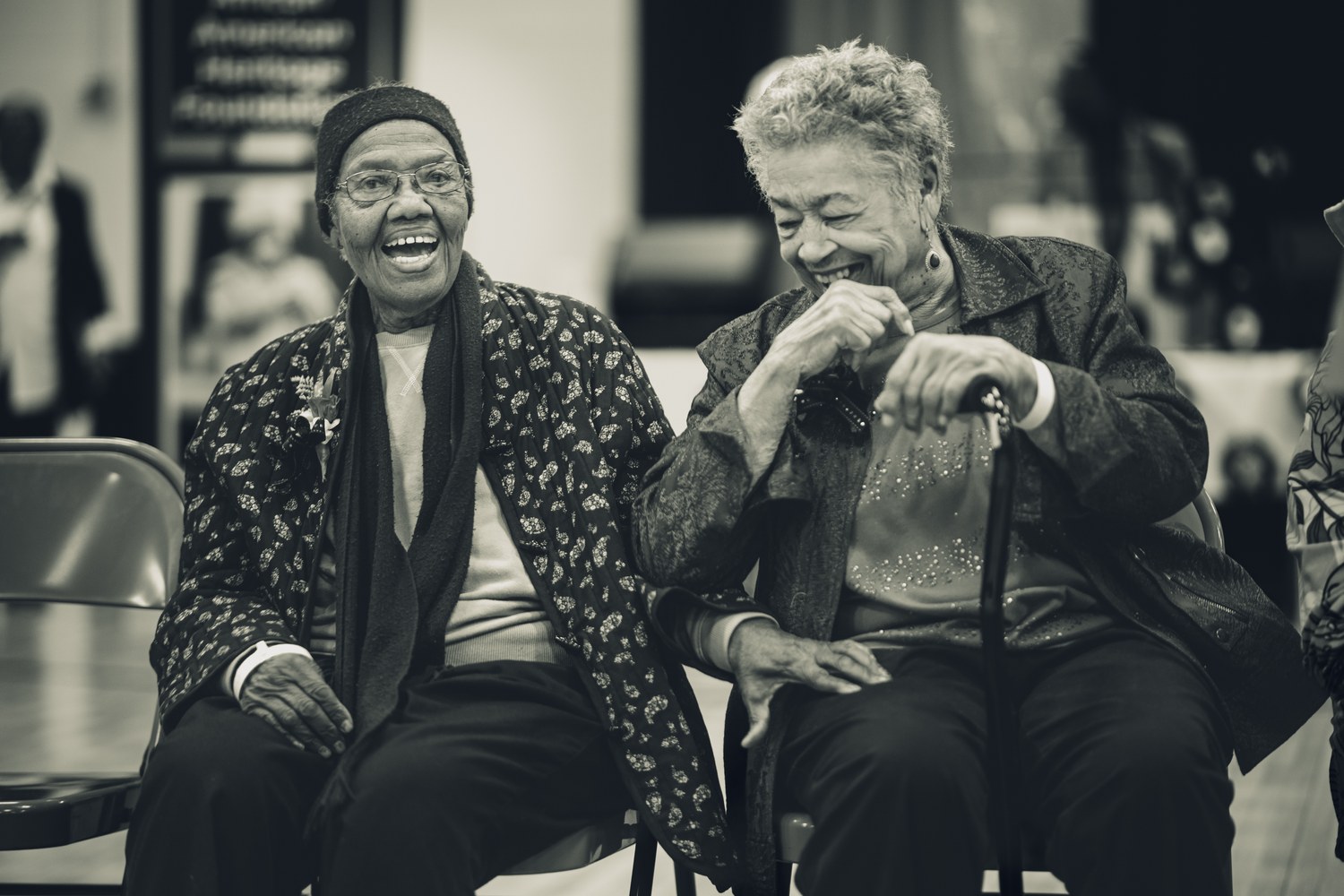 Two Creole elders sharing a laugh at the Heritage Hub